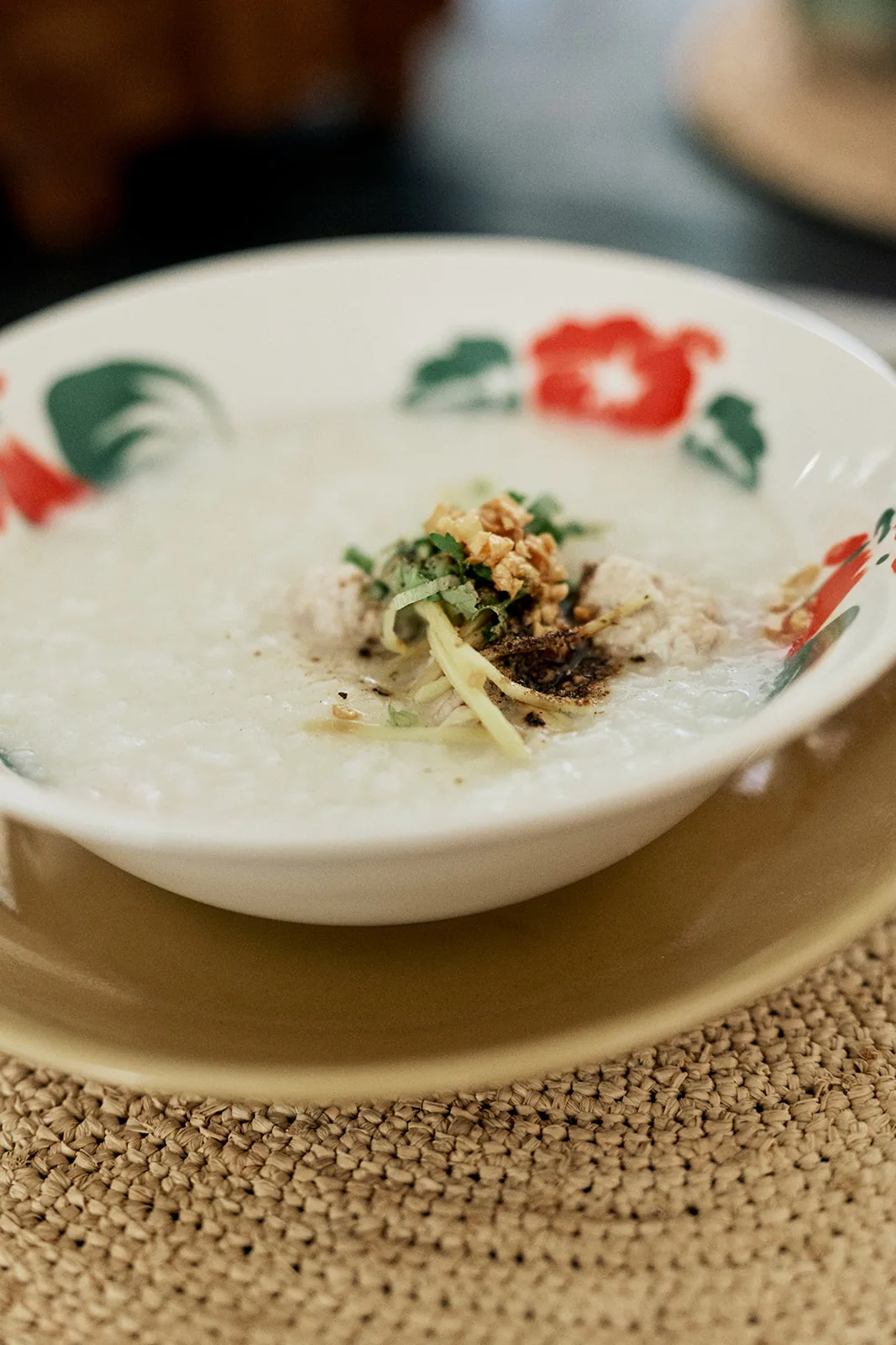 Jok, Thai rice congee, served in a hand-painted bowl