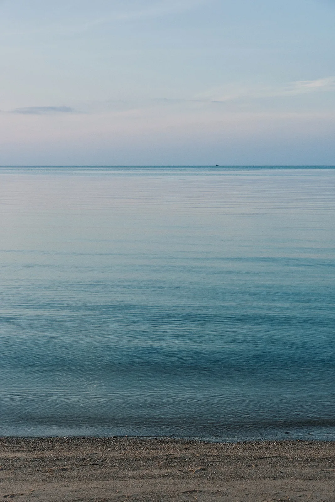 Soft pastel dawn over a calm sea