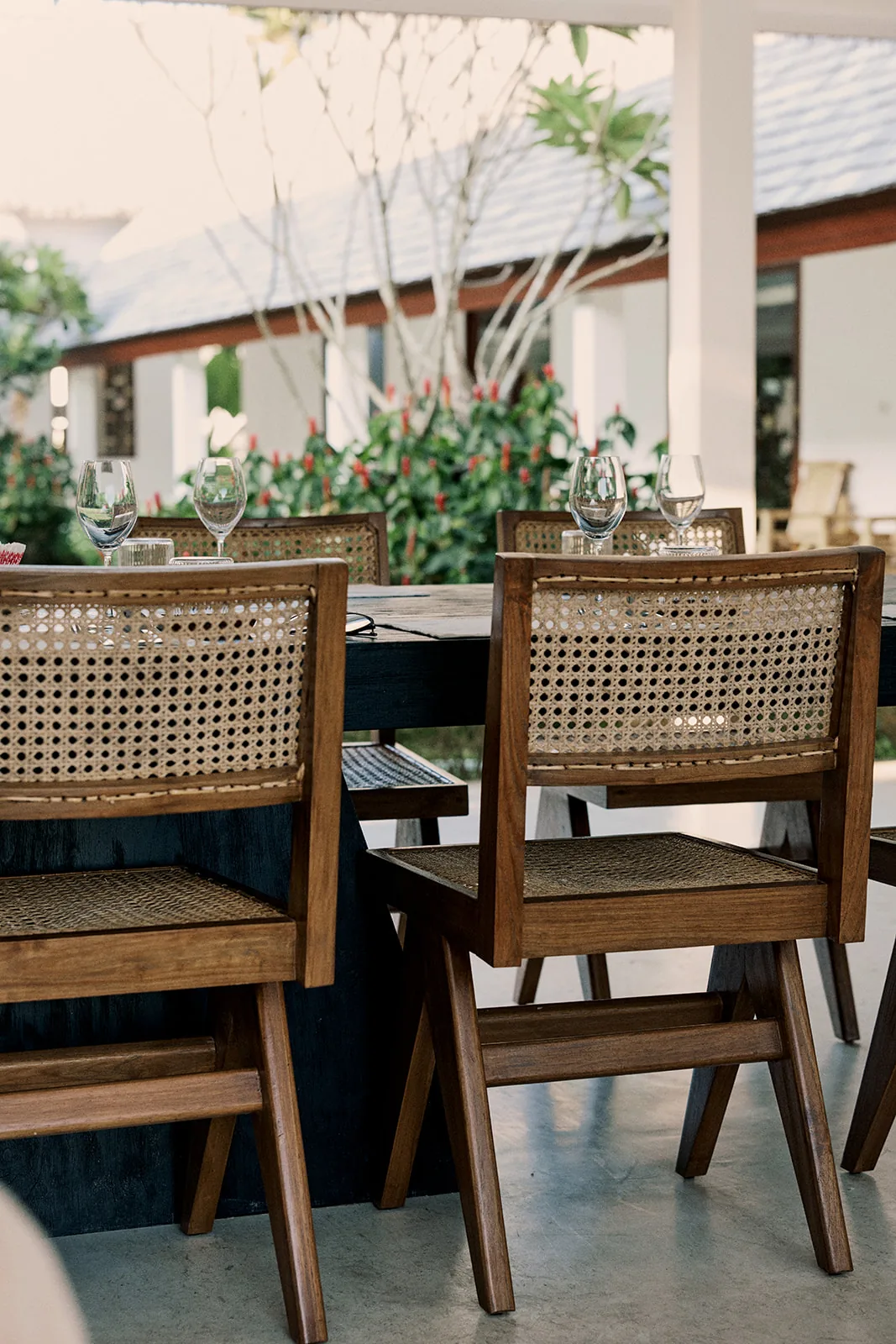 The dining terrace set for a meal among the gardens