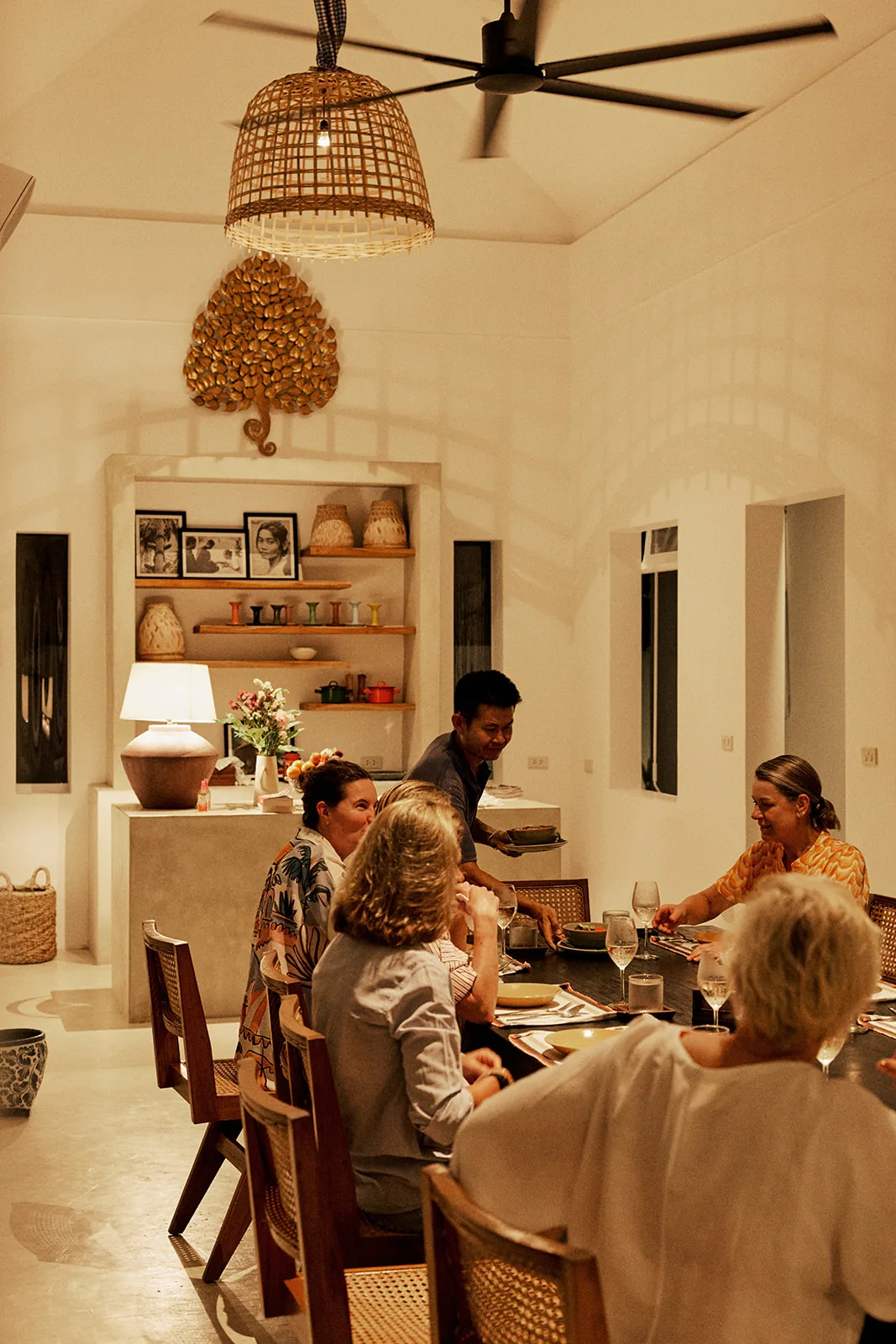 A family dinner beneath woven pendant lights