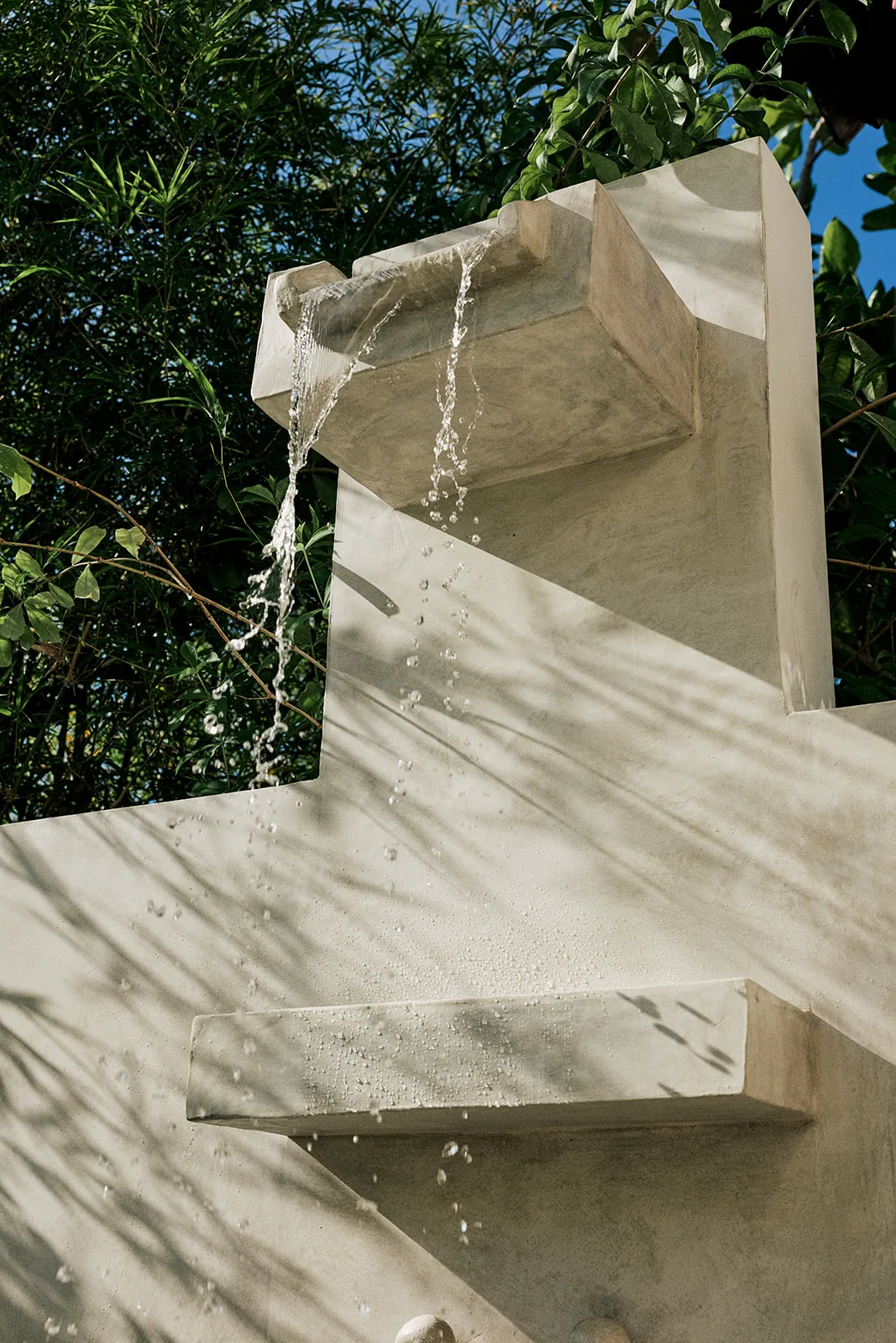 Water trickling from a stone fountain in the garden