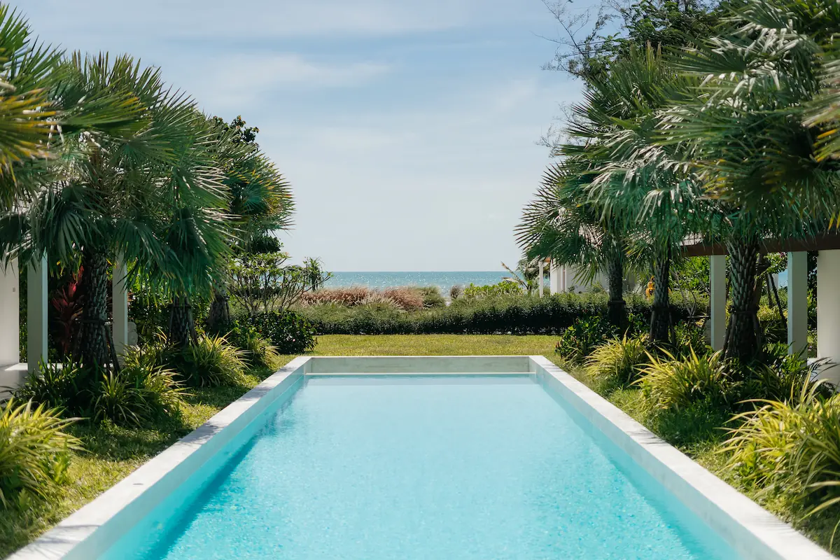 Villa Aditi 20-metre lap pool with sea view framed by palm trees, Bang Kao Beach, Koh Samui