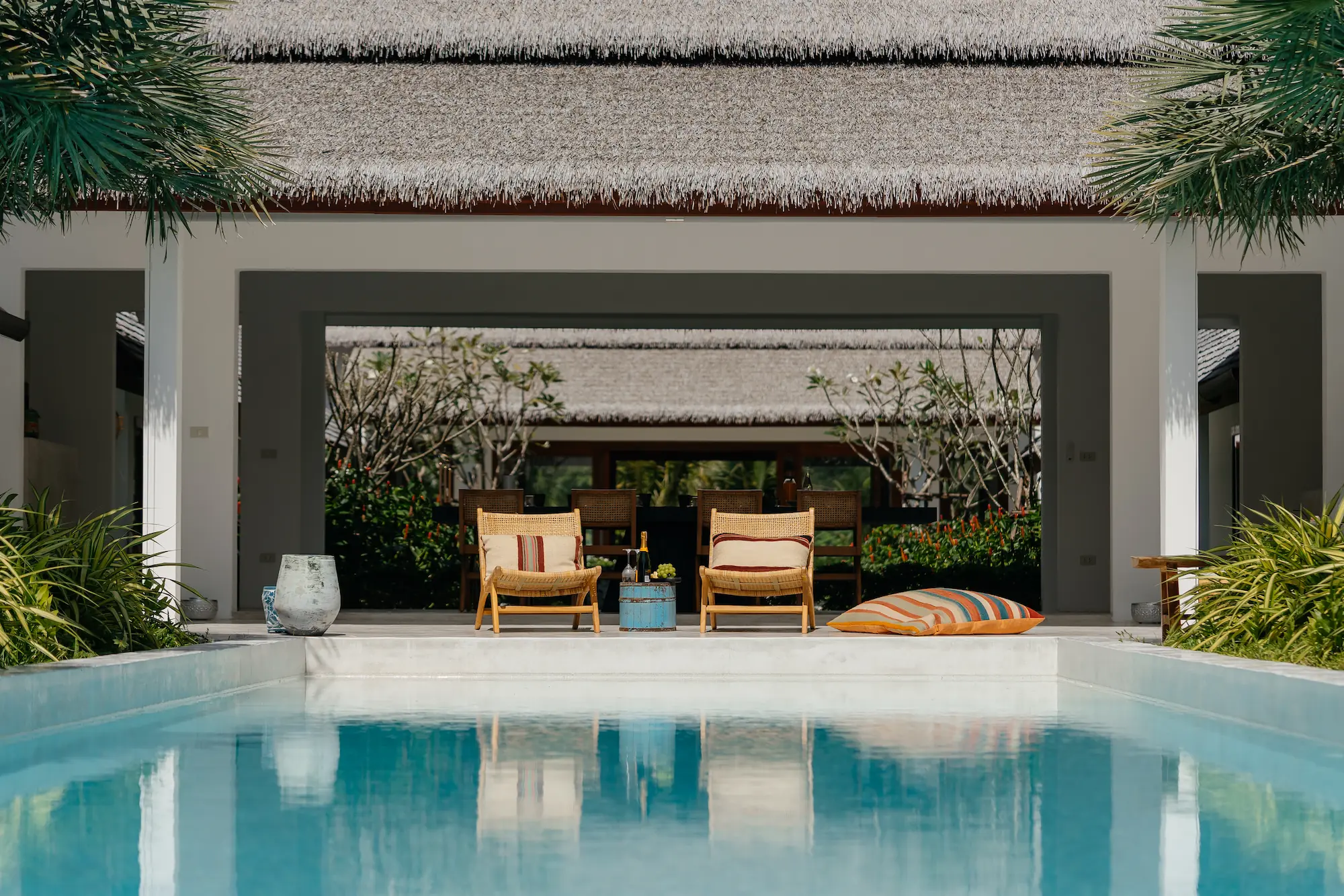 Lap pool and lounge chairs facing the sea at Villa Aditi, a six-bedroom beachfront villa on Koh Samui