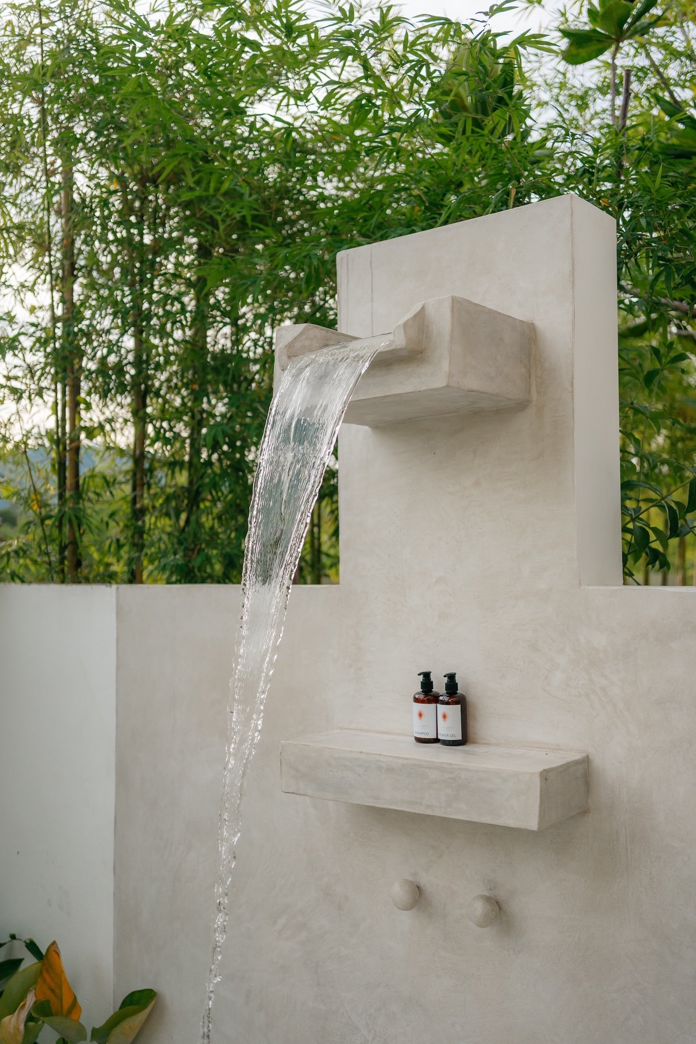 Open-air outdoor shower surrounded by tropical plants at Villa Aditi, Koh Samui